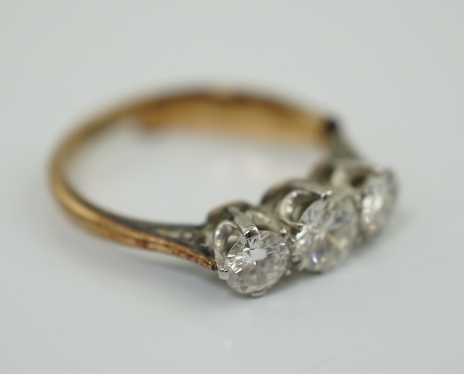 An 18ct gold, platinum and three stone diamond set ring